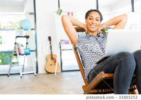 Portrait of smiling afro-american office worker sitting in offfice Portrait of smiling afro-american office worker sitting in offfice 33803252