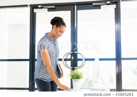 Portrait of smiling afro-american office worker in offfice Portrait of smiling afro-american office worker in offfice 33803261