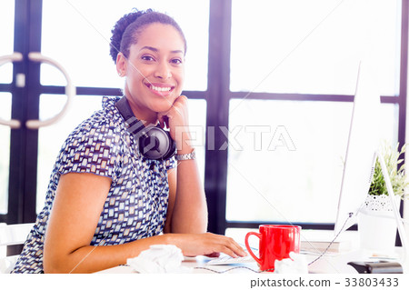 Portrait of smiling afro-american office worker in offfice 33803433