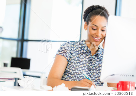 Portrait of smiling afro-american office worker sitting in offfice Portrait of smiling afro-american office worker sitting in offfice 33803518