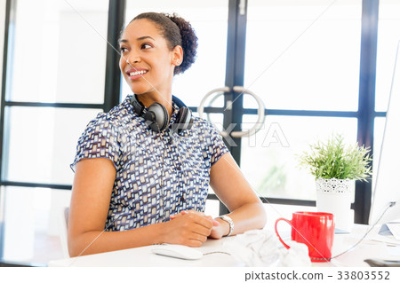 Portrait of smiling afro-american office worker sitting in offfice Portrait of smiling afro-american office worker sitting in offfice 33803552