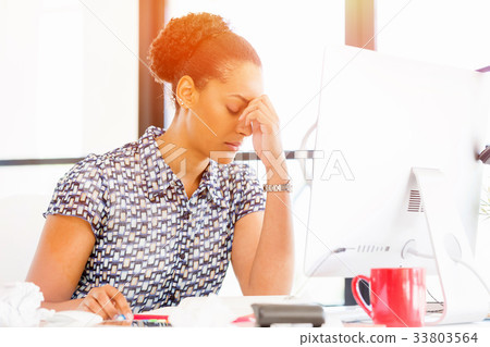 Portrait of tired afro-american office worker sitting in offfice Portrait of tired afro-american office worker sitting in offfice 33803564