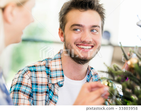Portrait of smiling office worker with little Christmas tree Portrait of smiling office worker with little Christmas tree 33803958