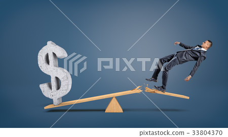 A big concrete dollar sign rests on a wooden A big concrete dollar sign rests on a wooden 33804370