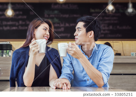 couple having coffee and hold hand in love couple having coffee and hold hand in love 33805251