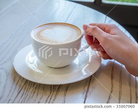 Latte in white cup as breakfast Latte in white cup as breakfast 33807060