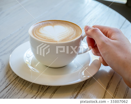 Latte in white cup as breakfast Latte in white cup as breakfast 33807062