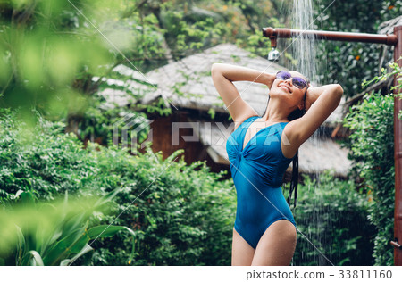 Taking a shower outdoor Taking a shower outdoor 33811160