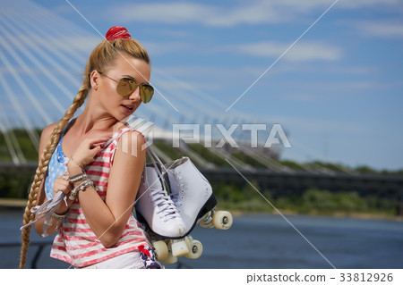 blonde girl in a vintage roller skates, wearing shorts, 33812926