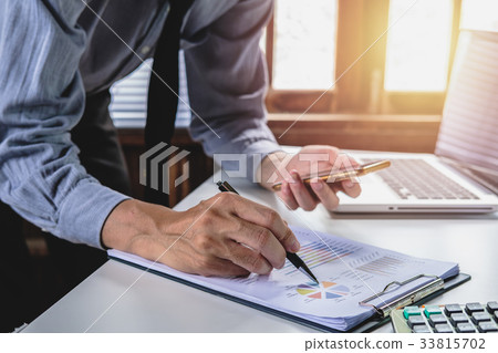 Businessman hand working  with business graph 33815702