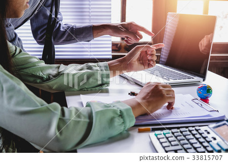 Business adviser analyzing financial figures Business adviser analyzing financial figures 33815707