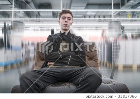 surround sound, young man on a leather armchair 33817360