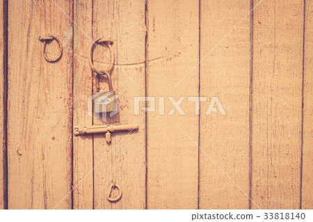 Old rustic wooden door with metal lock and latch Old rustic wooden door with metal lock and latch 33818140