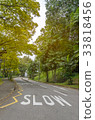 Word SLOW painted on the curve road to warn drive 33818456
