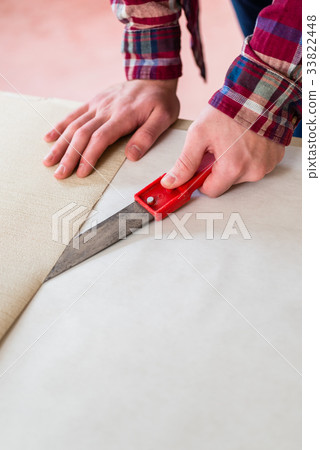 Close-up of the hands of a man cutting a new Close-up of the hands of a man cutting a new 33822448