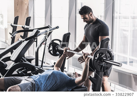 Senior male doing exercises with his trainer in Senior male doing exercises with his trainer in 33822907