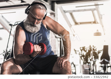 Confident old pensioner is spending time in gym 33822942