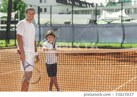Glad smiling family on court Glad smiling family on court 33823037