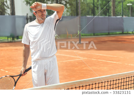 Tired adult sportsman on court Tired adult sportsman on court 33823131