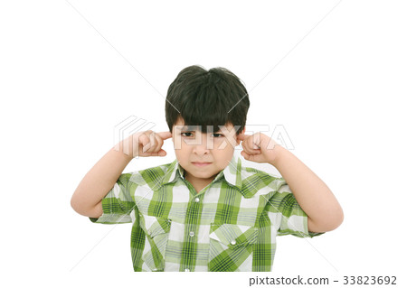 Photo of a boy with his fingers in his ears. Photo of a boy with his fingers in his ears. 33823692