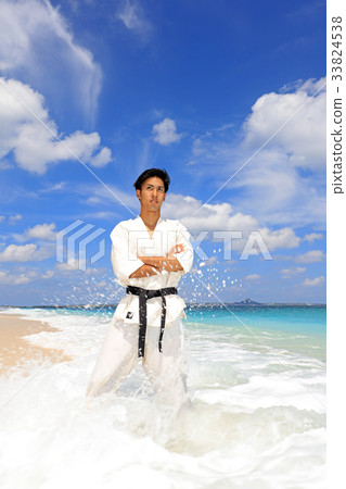 Men training on a beautiful tropical country beach 33824538