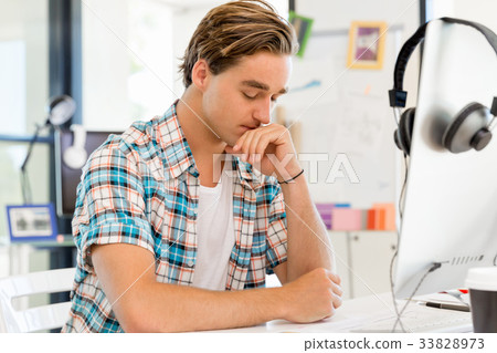 Young man working in office 33828973