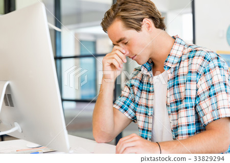 Young man working in office Young man working in office 33829294