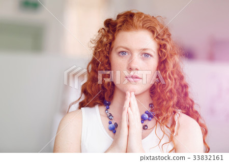 Closeup portrait of a young woman praying Closeup portrait of a young woman praying 33832161