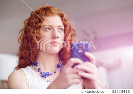 Happy beautiful young businesswoman using smart phone smiling 33833416