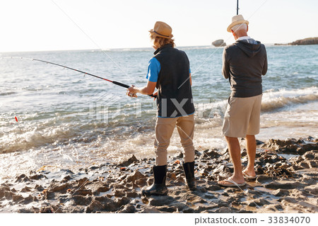 Senior man fishing with his grandson 33834070