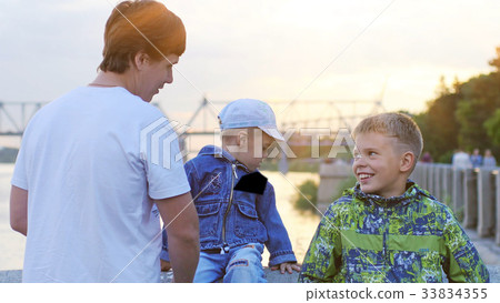 Father with his children on promenade during 33834355