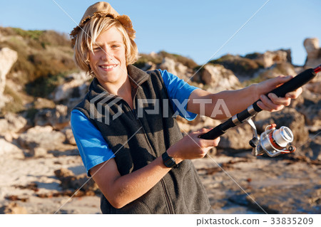 Teenage boy fishing at sea Teenage boy fishing at sea 33835209