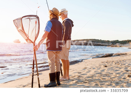 Senior man fishing with his grandson Senior man fishing with his grandson 33835709