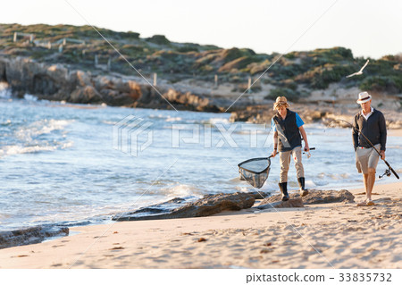 Senior man fishing with his grandson Senior man fishing with his grandson 33835732