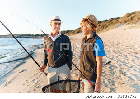 Senior man fishing with his grandson 33835752