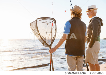 Senior man fishing with his grandson Senior man fishing with his grandson 33835868