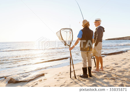 Senior man fishing with his grandson Senior man fishing with his grandson 33835871
