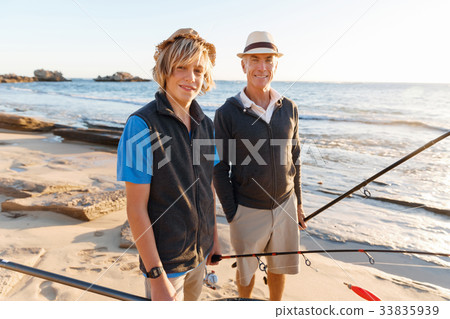 Senior man fishing with his grandson 33835939
