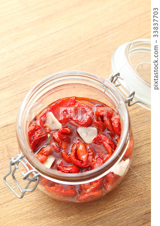 Dried tomatoes bottling wooden table copy space from above Dried tomatoes bottling wooden table copy space from above 33837703