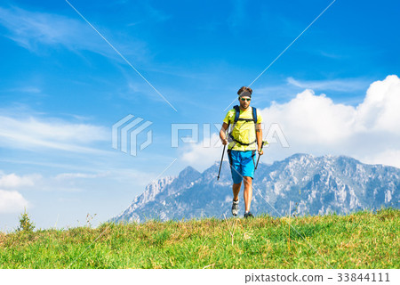 Young man practicing physical activity mountain and running with 33844111