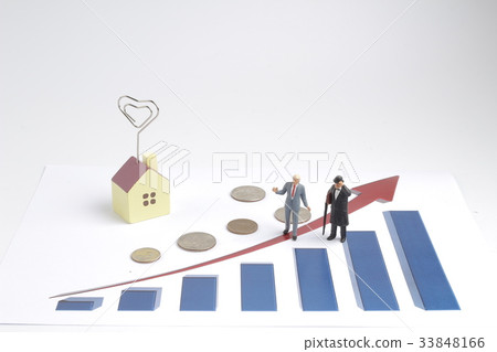 Figurines on coins in front of toy house Figurines on coins in front of toy house 33848166