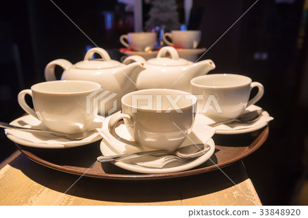 White teaset on tray in restaurant White teaset on tray in restaurant 33848920