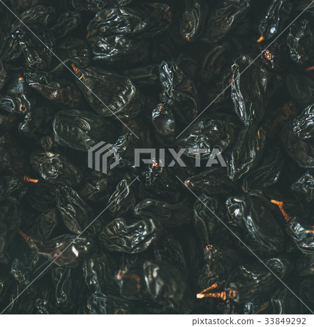 Flat-lay of black dried raisins, top view, square 33849292