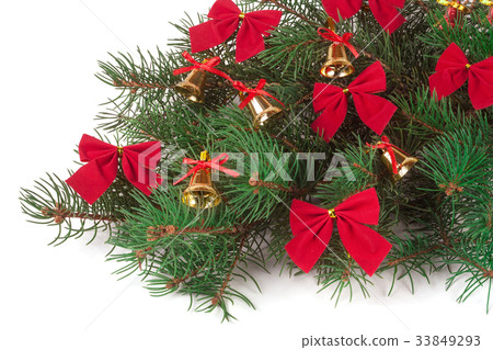 branch of Christmas tree decorated bells and bows 33849293
