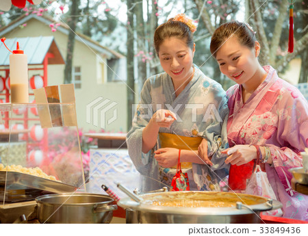 cheerful sweet women friends pointing food stall cheerful sweet women friends pointing food stall 33849436