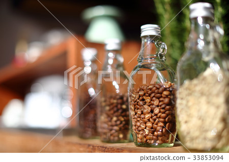 Coffee beans inside the clear bottle. 33853094