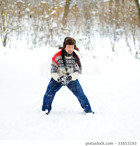 man playing snowballs 33853193