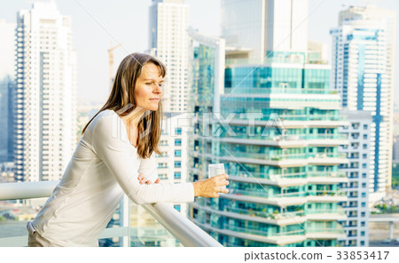 Woman on a highrise balcony 33853417