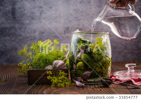Filling jar with cucumbers for winter pickles 33854777