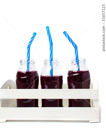 Blueberry juice bottles in a white wooden box Blueberry juice bottles in a white wooden box 33857123